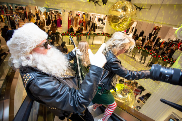 Rock santa plays a guitar