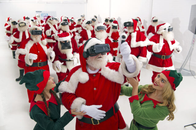 Little helpers assist Santas with their VR headsets