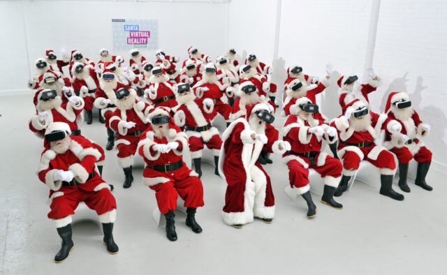 Santas sit in lines with VR headsets