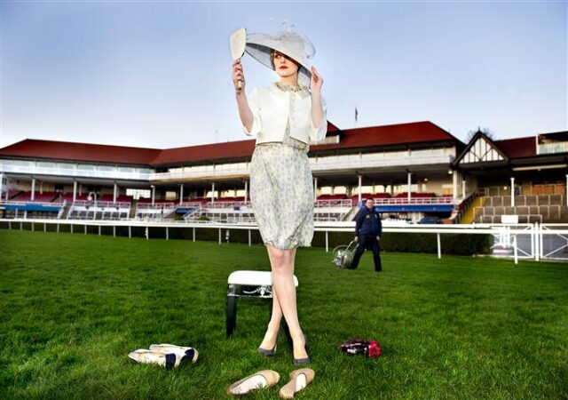 A model poses on a racecourse