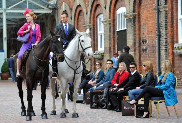 Models on horseback walk a fashion show