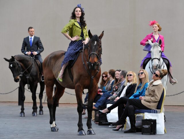 models on horseback pose for a fashion show