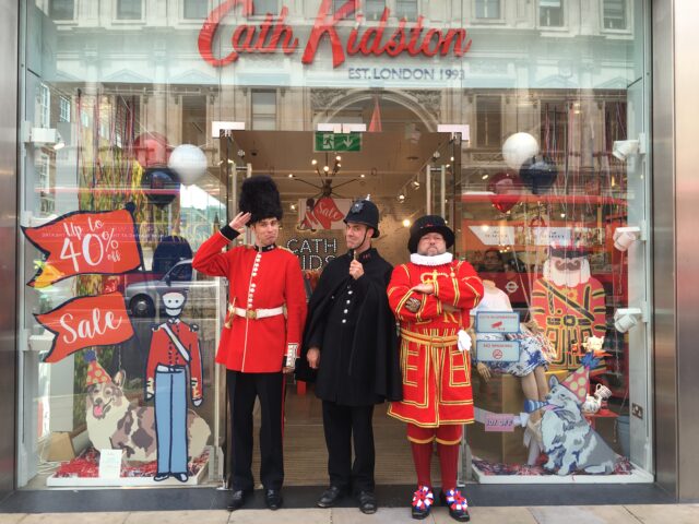 Policeman salutes on front of Cath kidston store