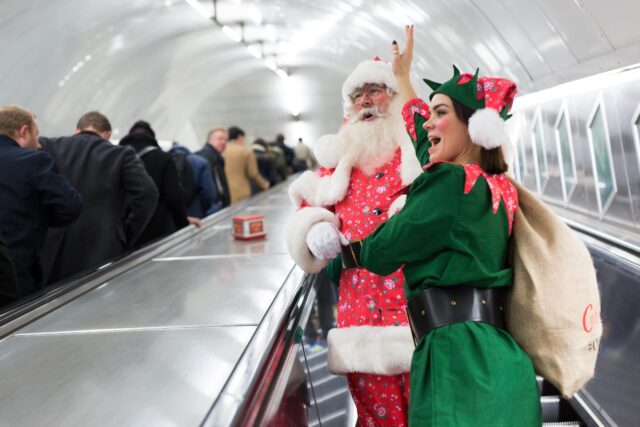 Santaand his elf on an escalator