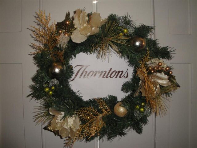 A wreath with Thorntons written in the middle